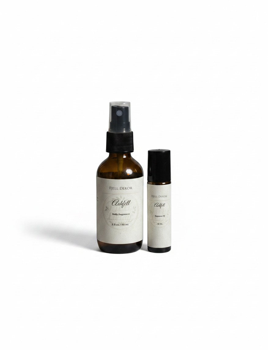 Fjell Dekor Ashfell body fragrance duo featuring a 2oz amber glass spray bottle and a 10ml rollerball perfume.