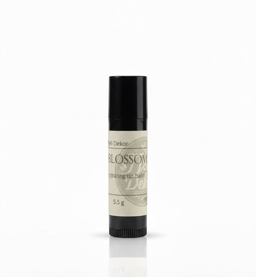 Fjell Dekor Blossom Kiss 5.5g natural hydrating lip balm in a black tube with a botanical label.