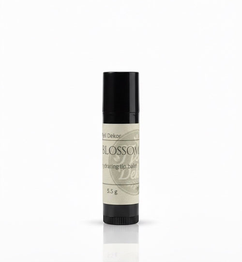 Fjell Dekor Blossom Kiss 5.5g natural hydrating lip balm in a black tube with a botanical label.