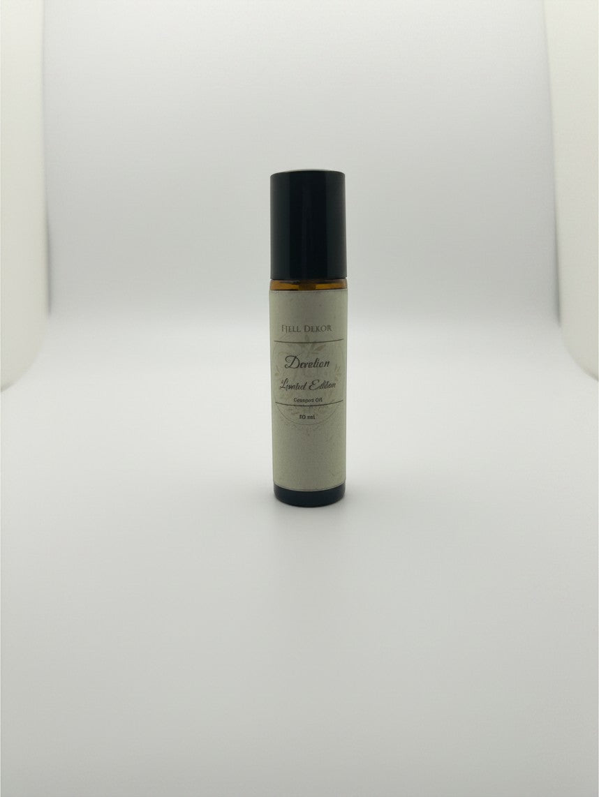 Fjell Dekor Devotion 10ml botanical body fragrance roller in an amber glass bottle with a minimalist label.