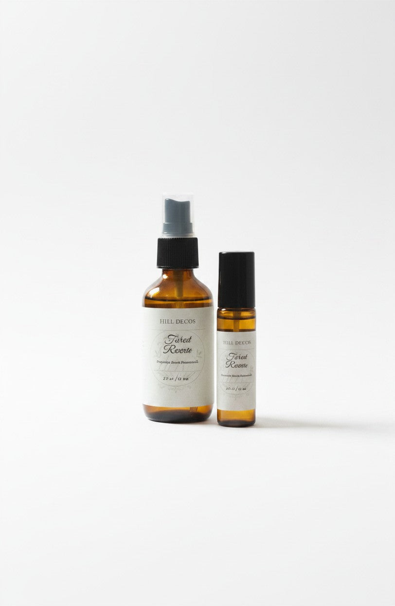 Fjell Dekor Forest Reverie body mist and fragrance roller duo in amber glass bottles with botanical labels.