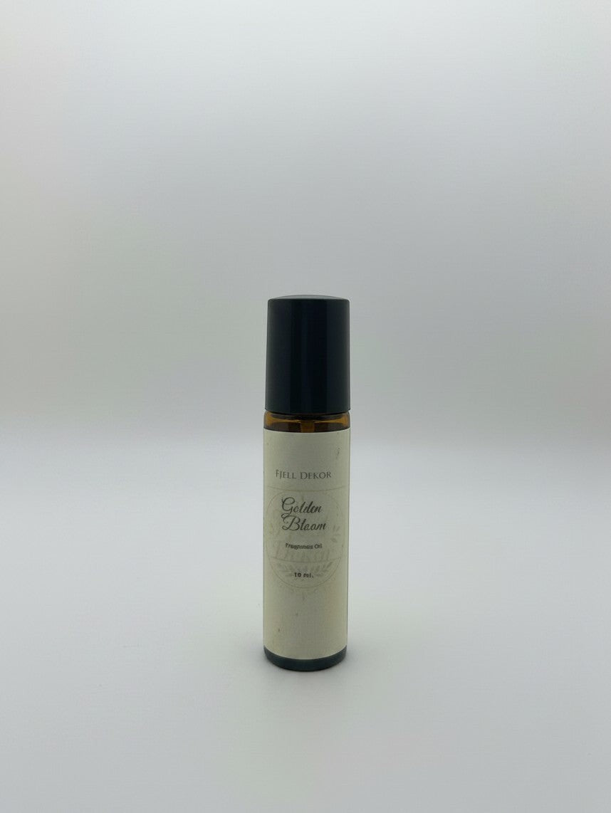 Fjell Dekor Golden Bloom 10ml fragrance roller with amber glass bottle and black cap for botanical perfume application