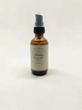 Fjell Dekor 2oz Limited Edition Intimacy Massage Oil in an amber glass bottle with a black pump dispenser.