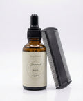 Fjell Dekor Ironwood 1oz beard oil in an amber glass dropper bottle with a black grooming comb on a white background.