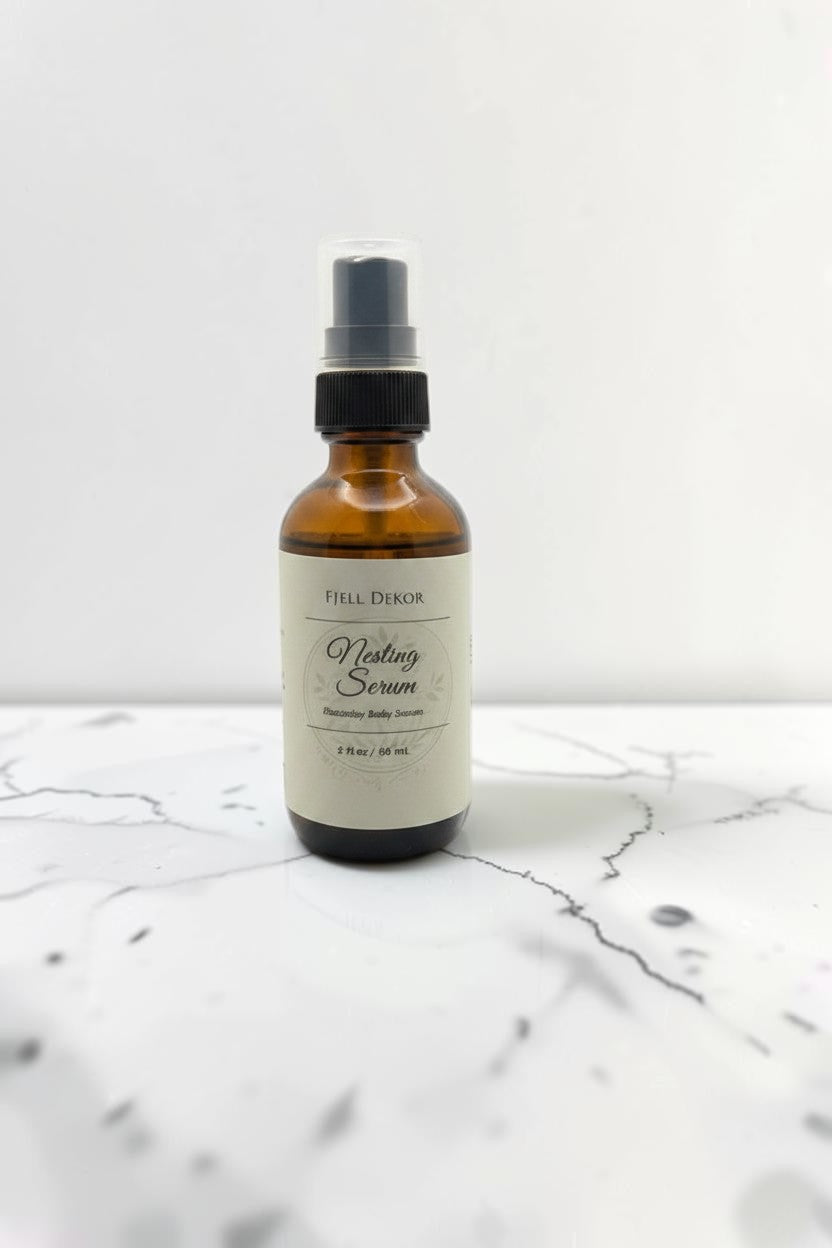Fjell Dekor Nesting Serum in a 2 fl oz amber glass spray bottle with a black pump on a white background