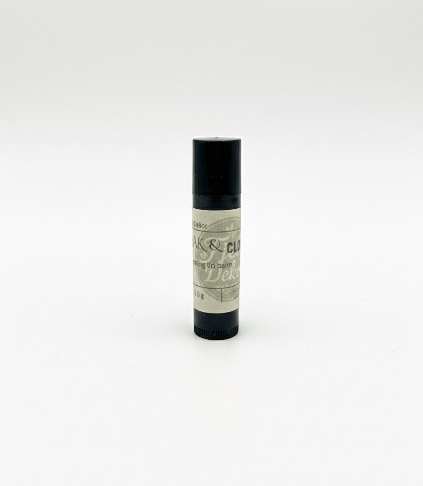 Fjell Dekor Oak and Clove 5.5g natural lip balm in a black tube with a matte finish for dry, chapped lips.