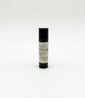 Fjell Dekor Oak and Clove 5.5g natural lip balm in a black tube with a matte finish for dry, chapped lips.
