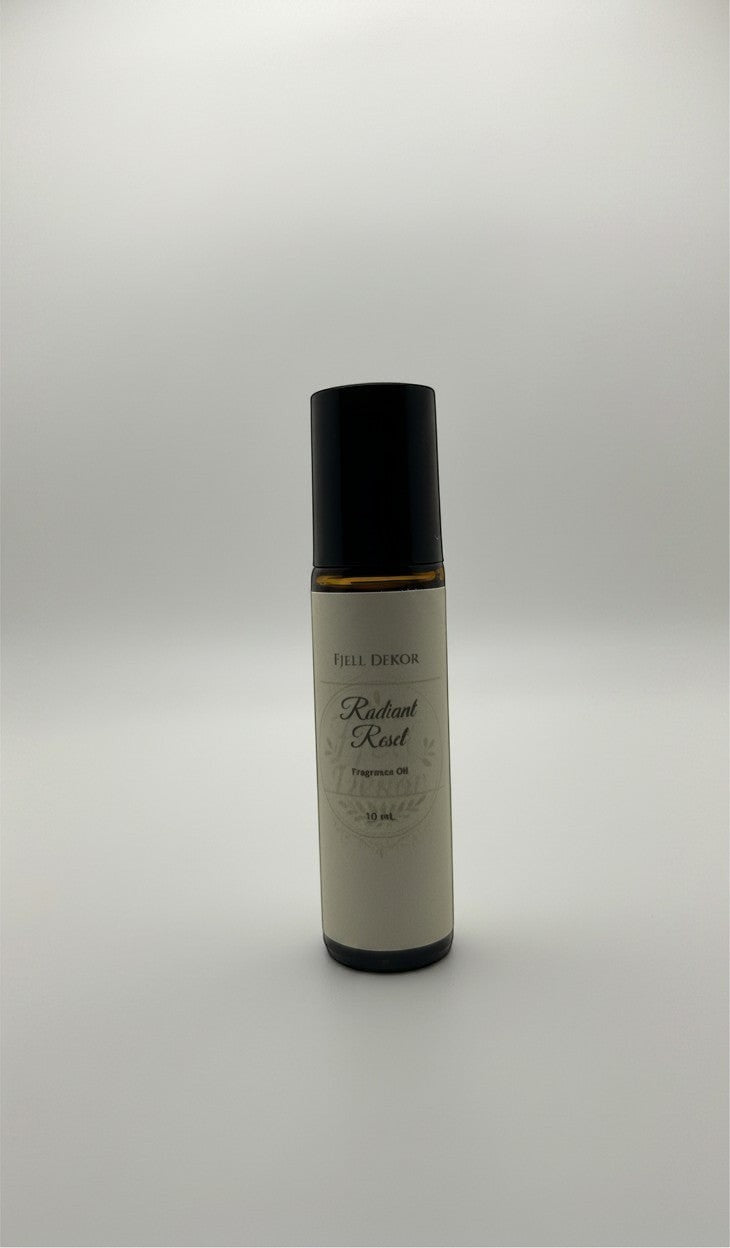 Fjell Dekor Radiant Reset aromatherapy roll-on bottle with amber glass and black cap for postpartum support