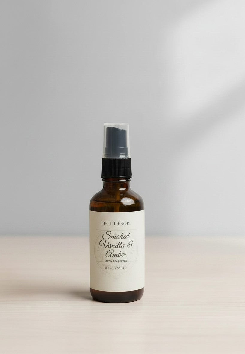 Fjell Dekor Smoked Vanilla & Amber 2oz body fragrance mist in an amber glass spray bottle on a light surface.